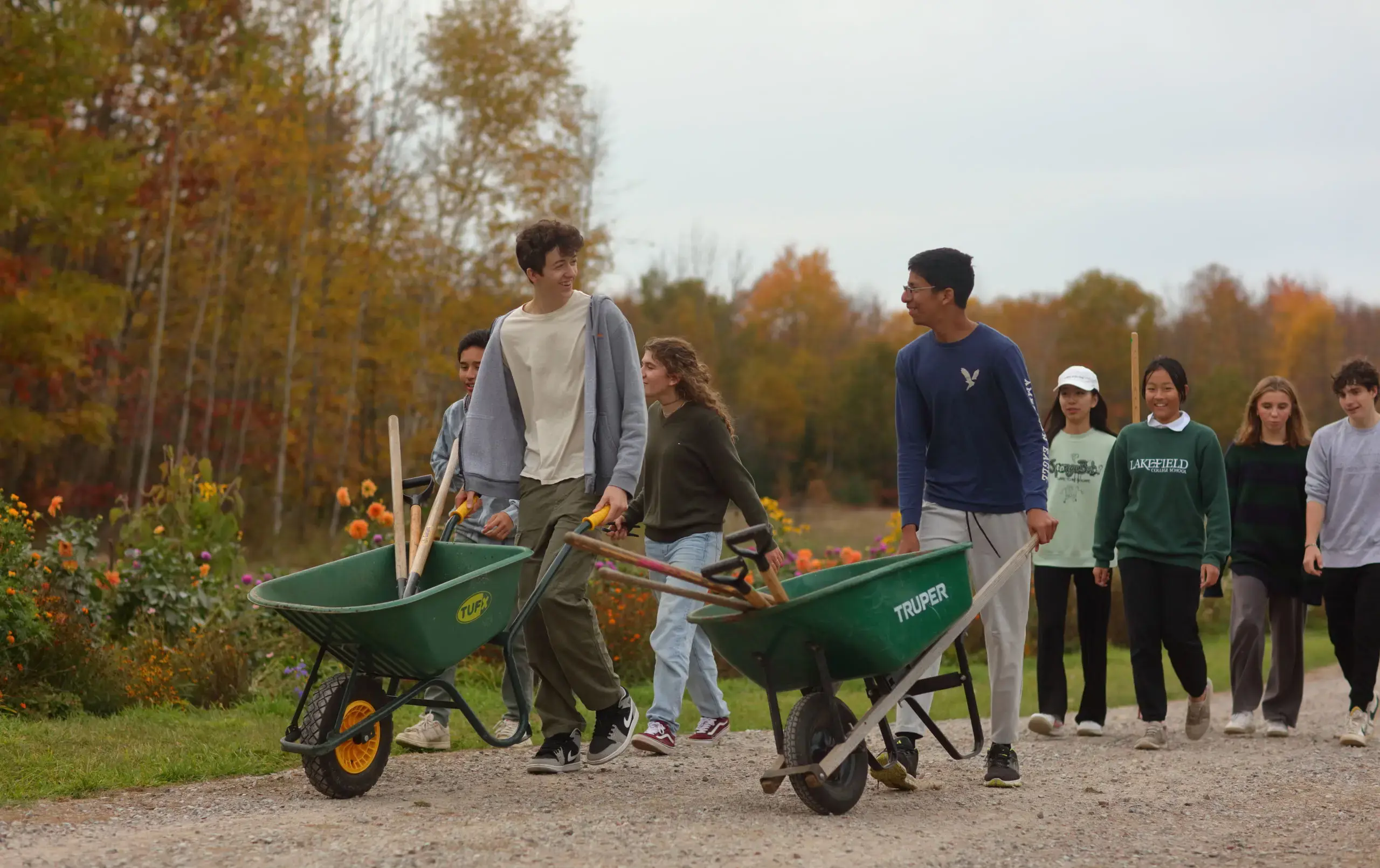 Students wheeling wheelbarrows