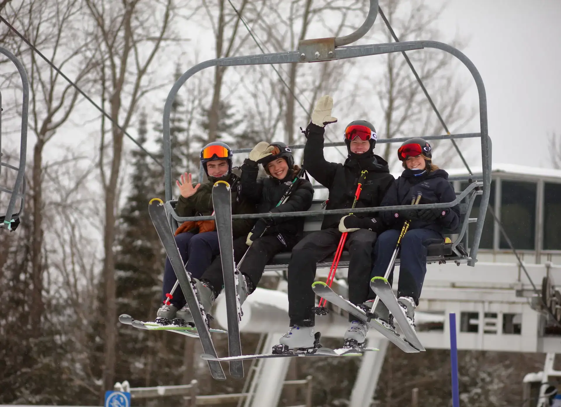 Students waving from ski lift