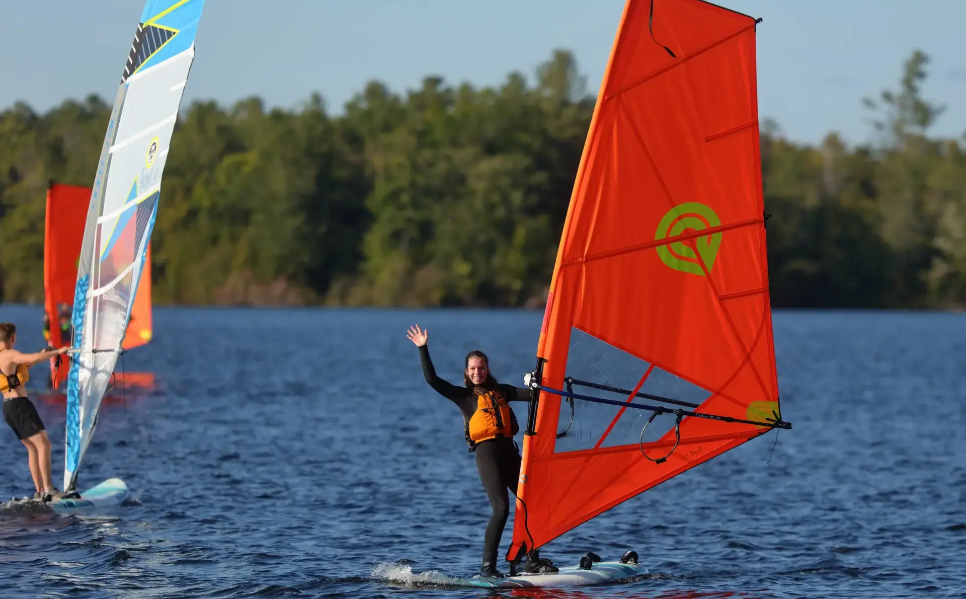 Students windsurfing on lake