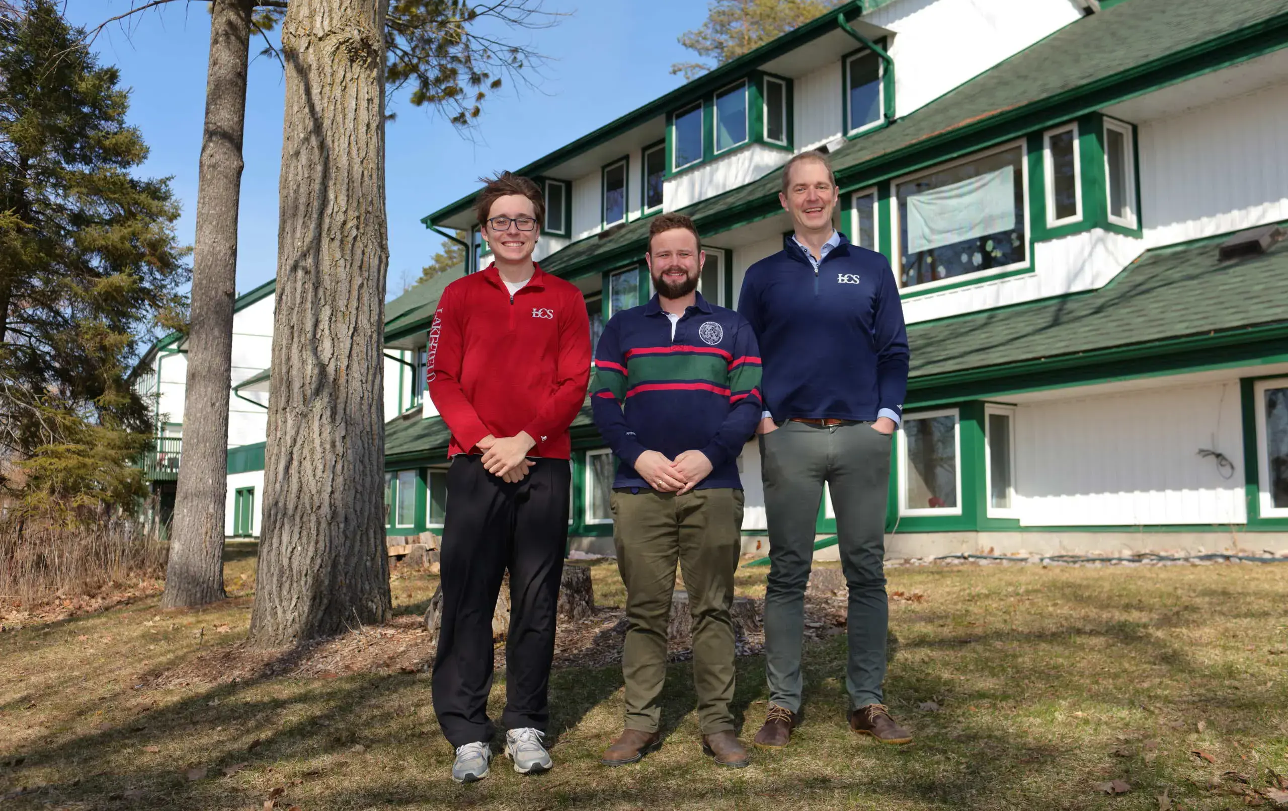 Ryder House team standing outside dorm building