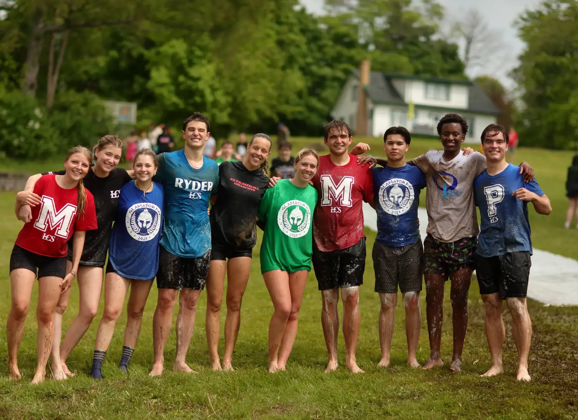 Group of students standing outside, wearing House t-shirts