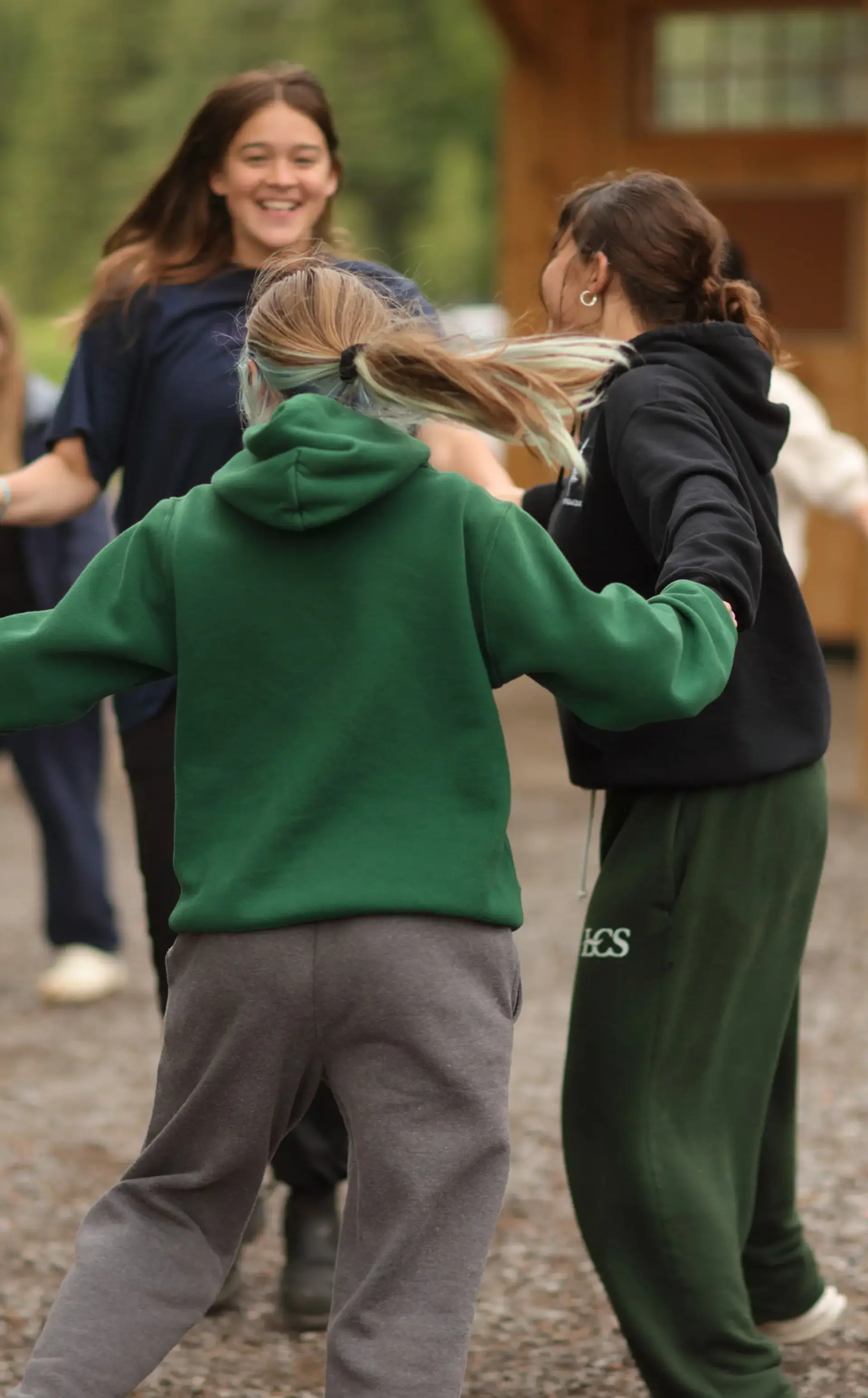 Students and teacher playing ring around the rosies