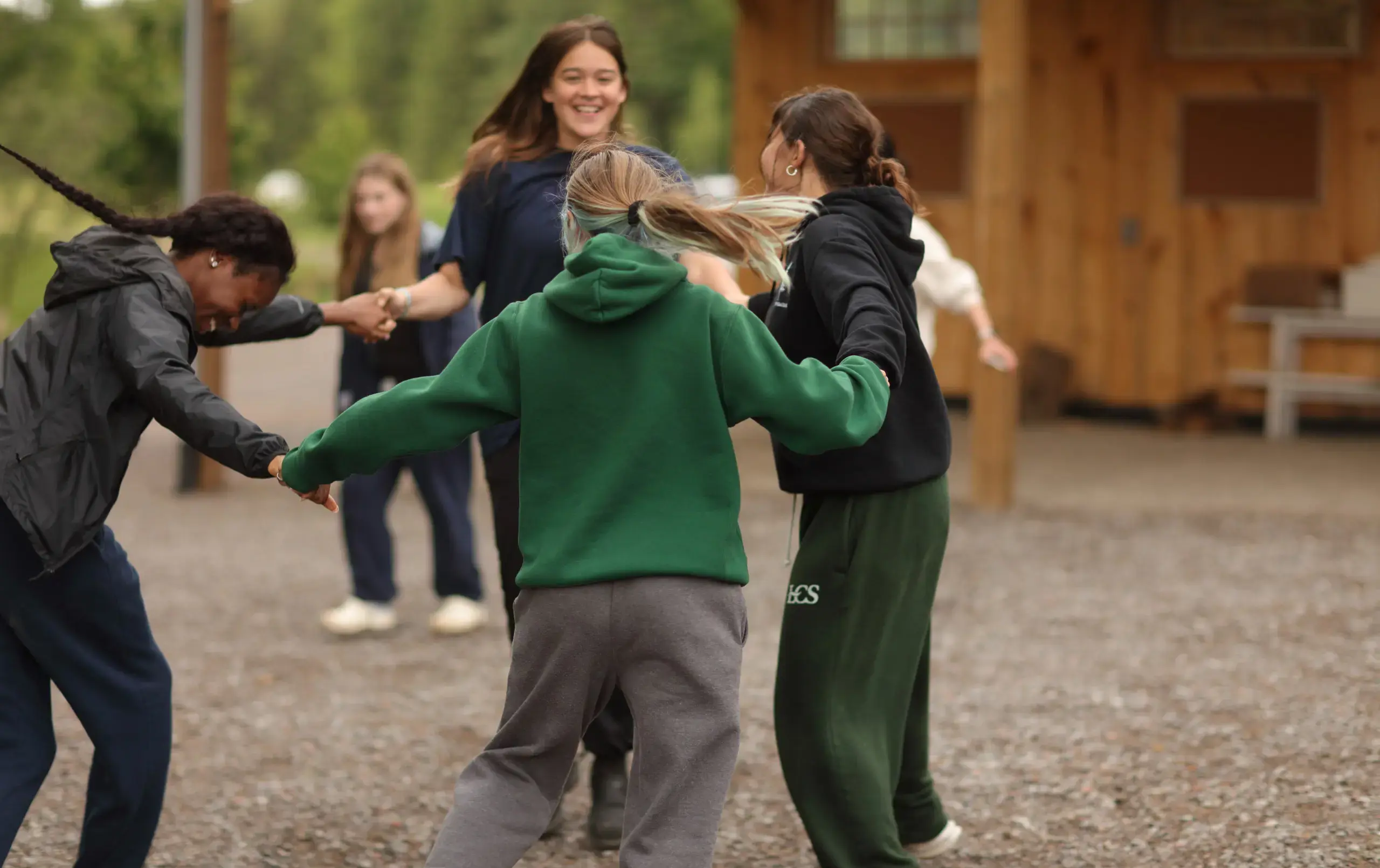 Students and teacher playing ring around the rosies