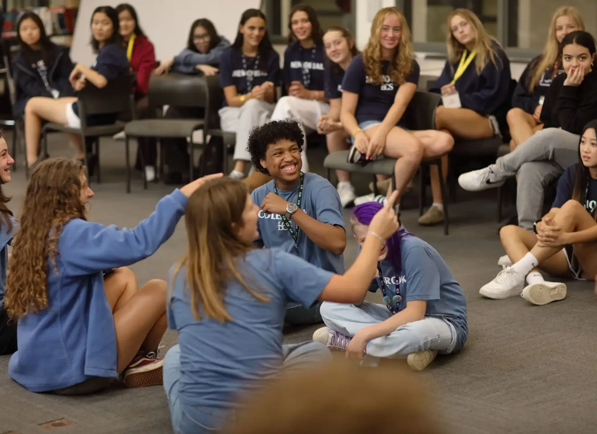 Students sitting cross-legged on floor