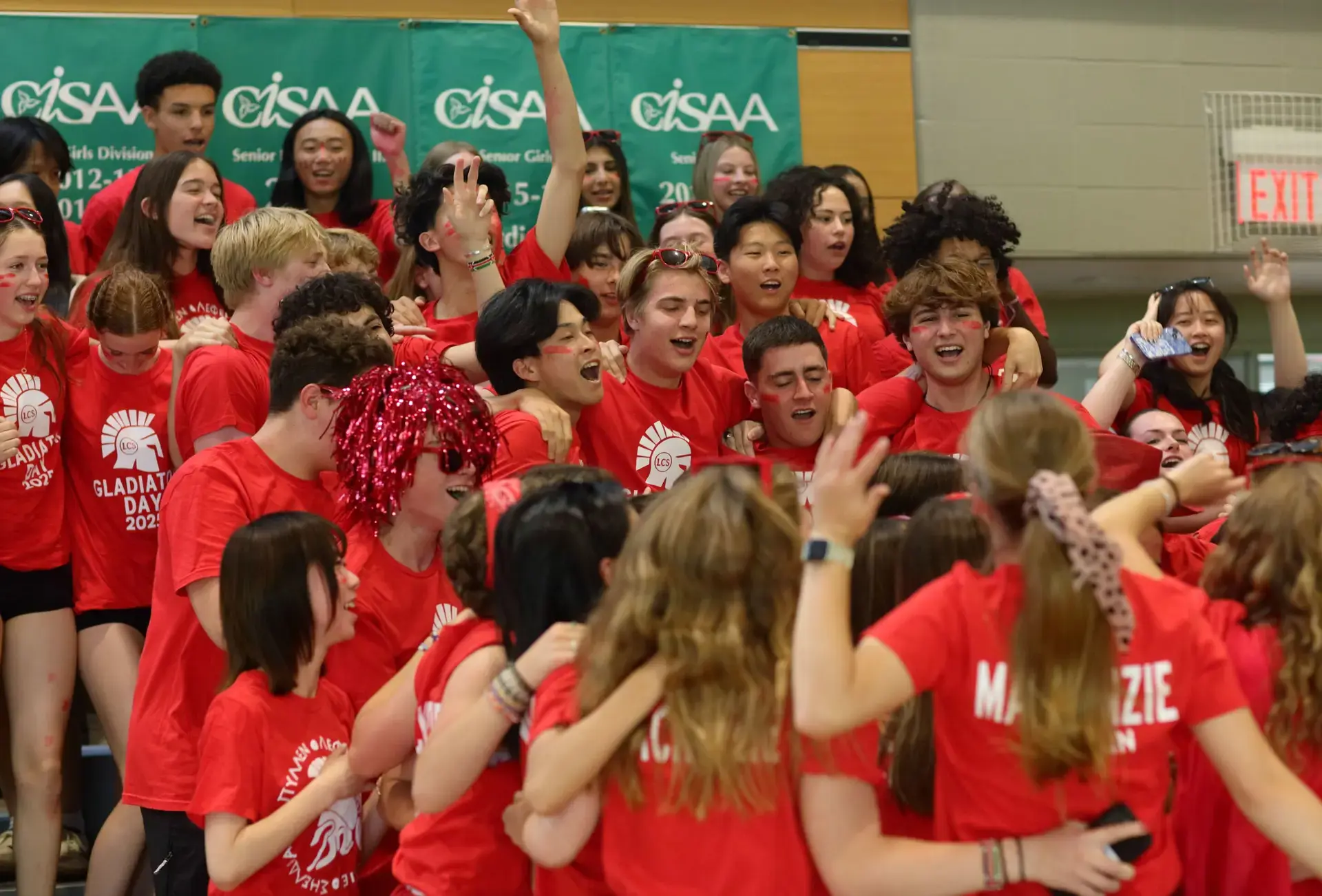 Students wearing red t-shirts celebrating