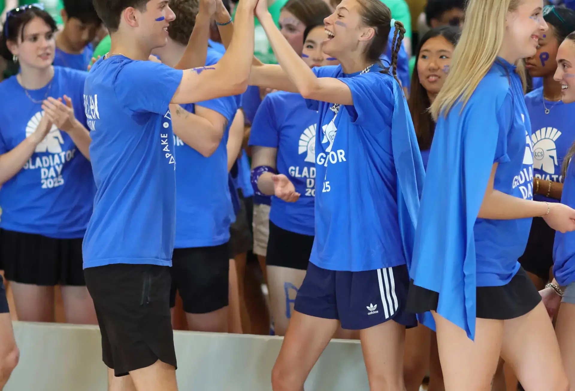 Students high-fiving at Gladiator Day