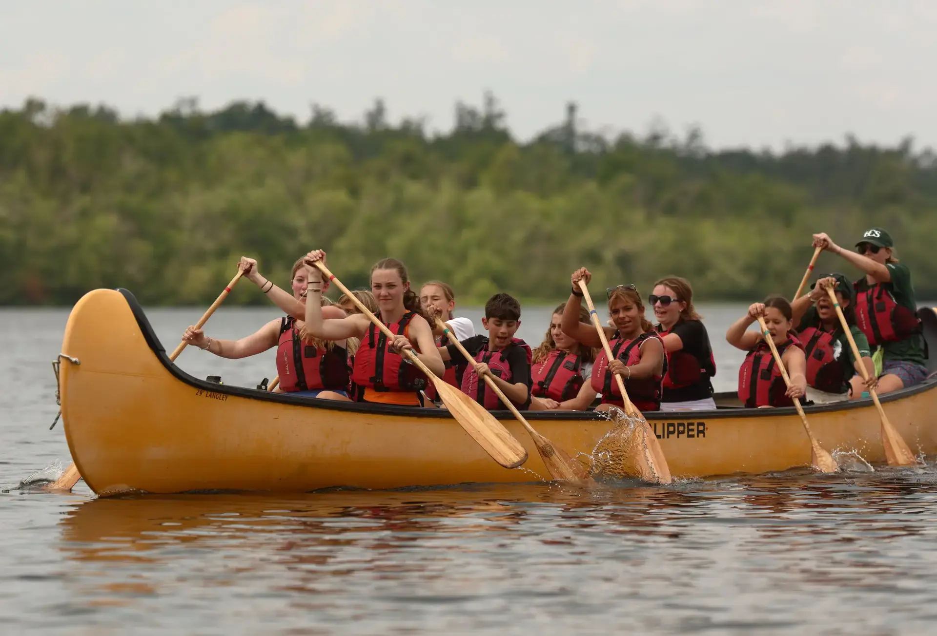 Group of students piloting canoe