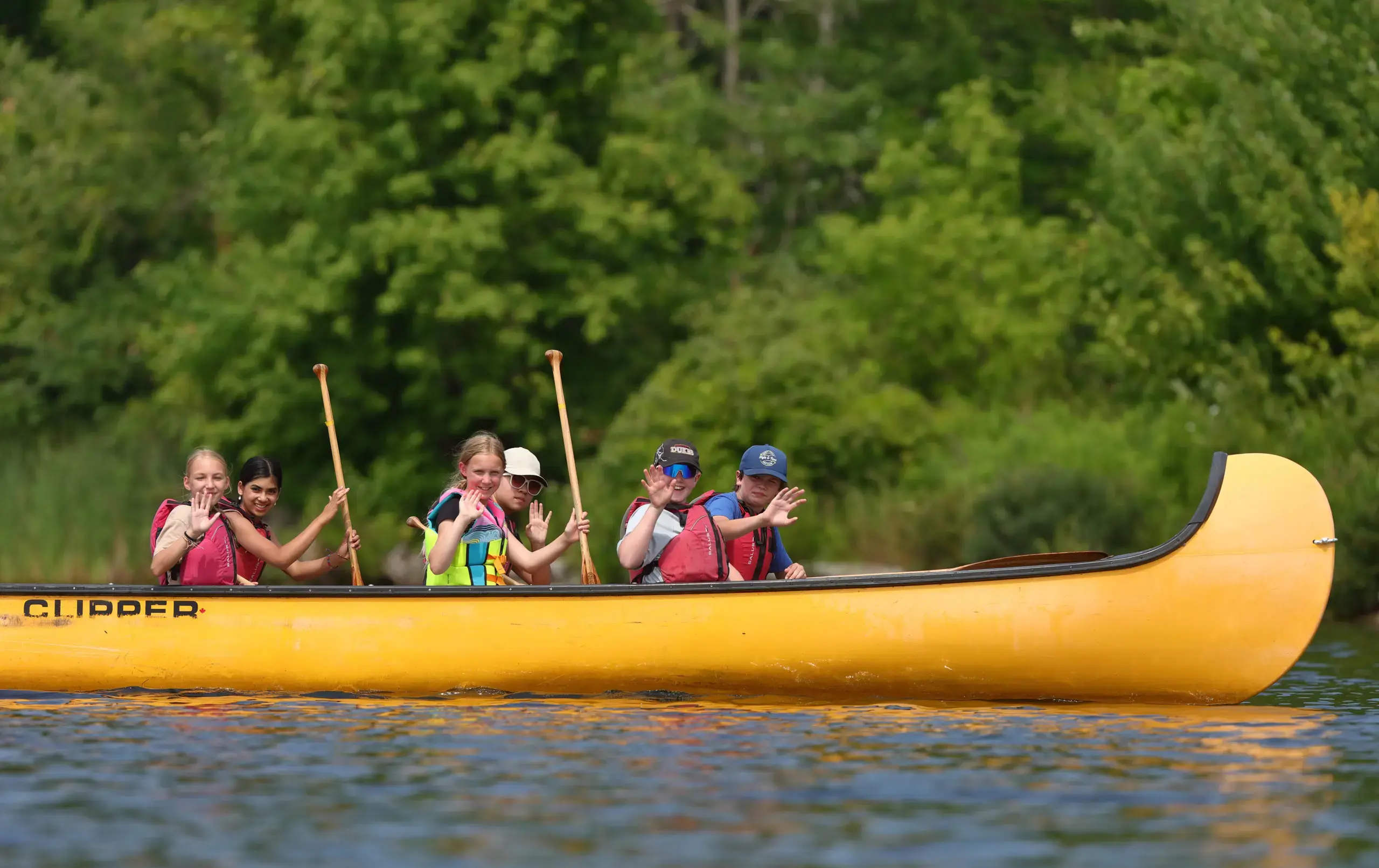 Students piloting canoe