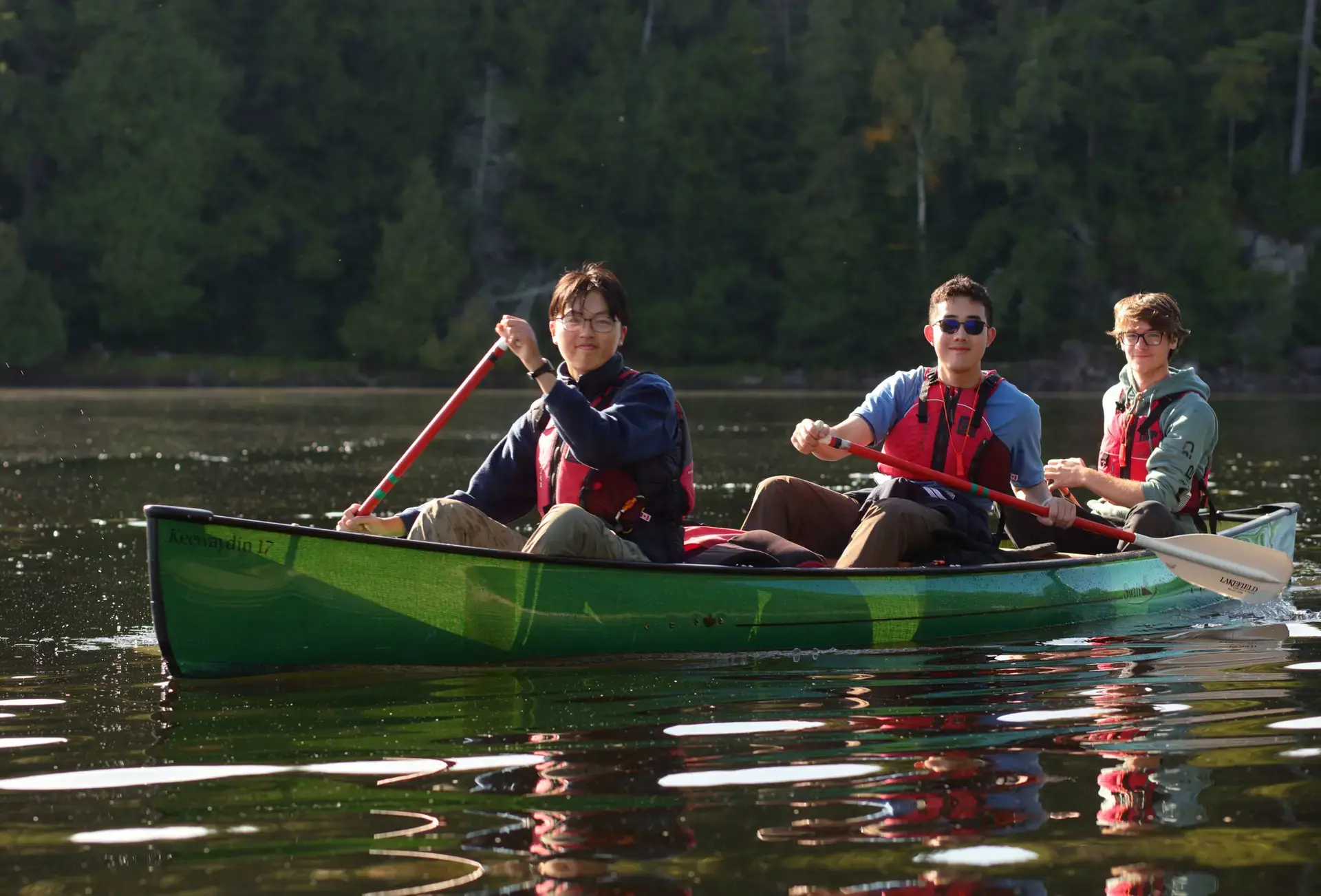 Students piloting canoes