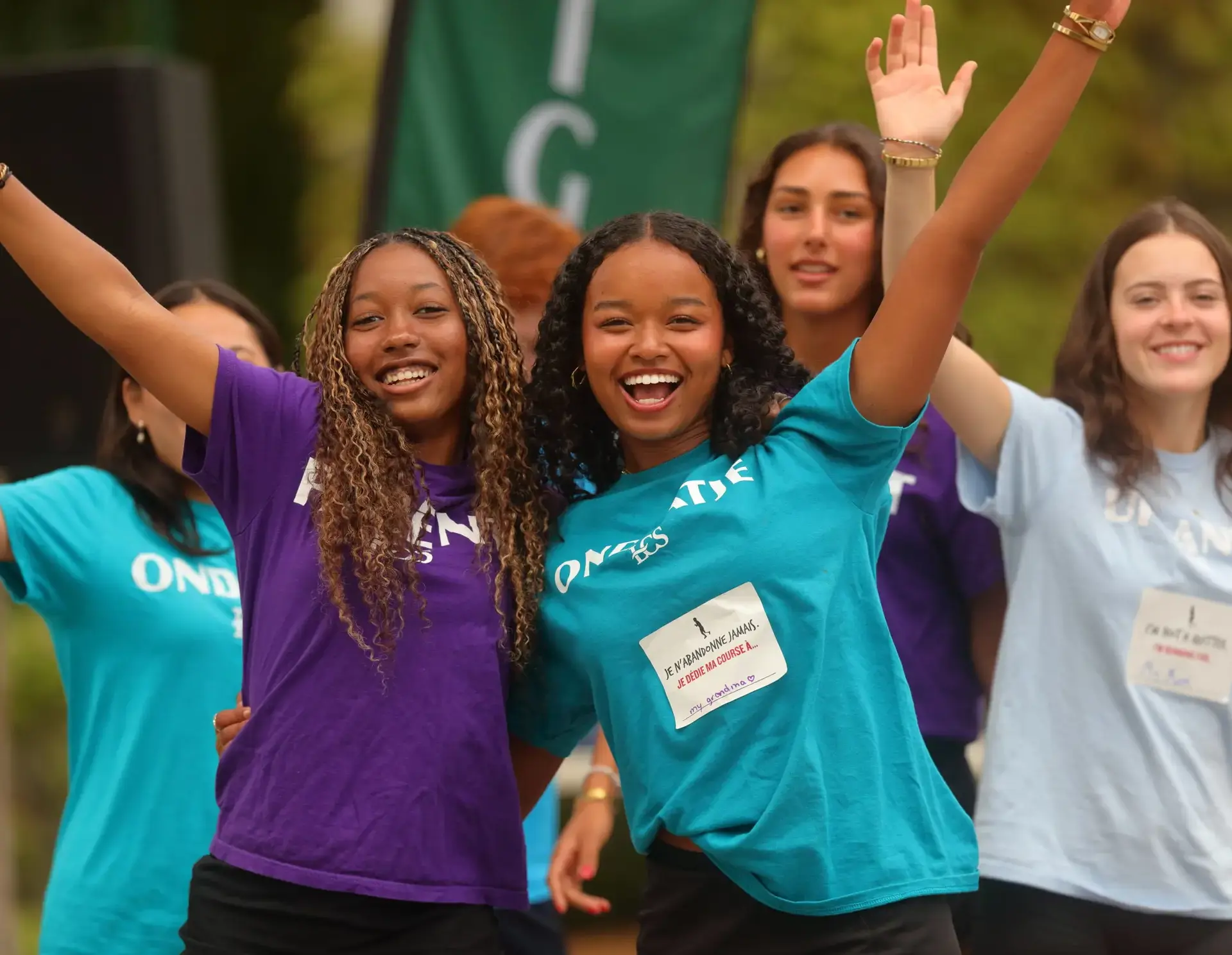 Group of students wearing team colours, waving