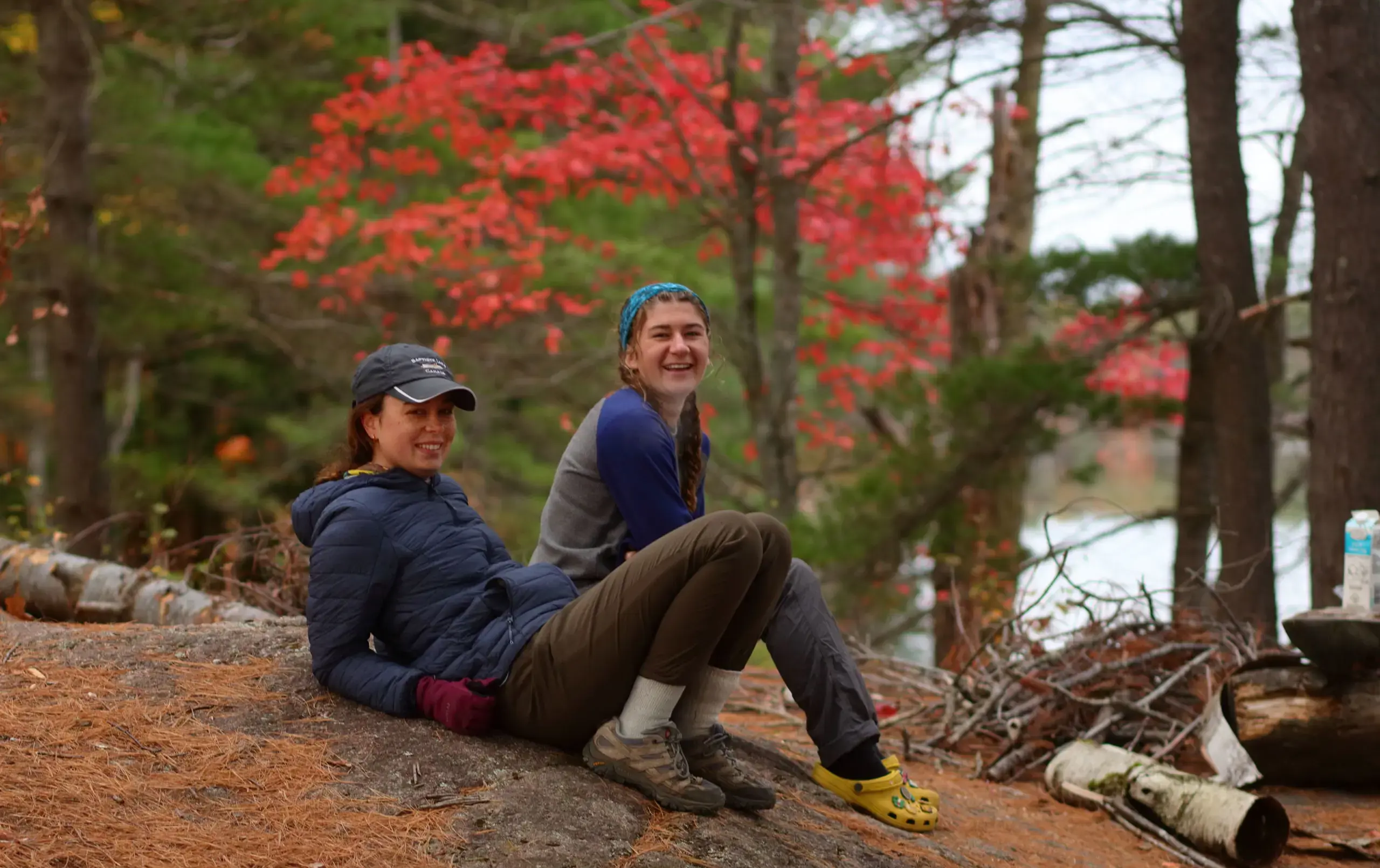 Students sitting on ground on autumnal day