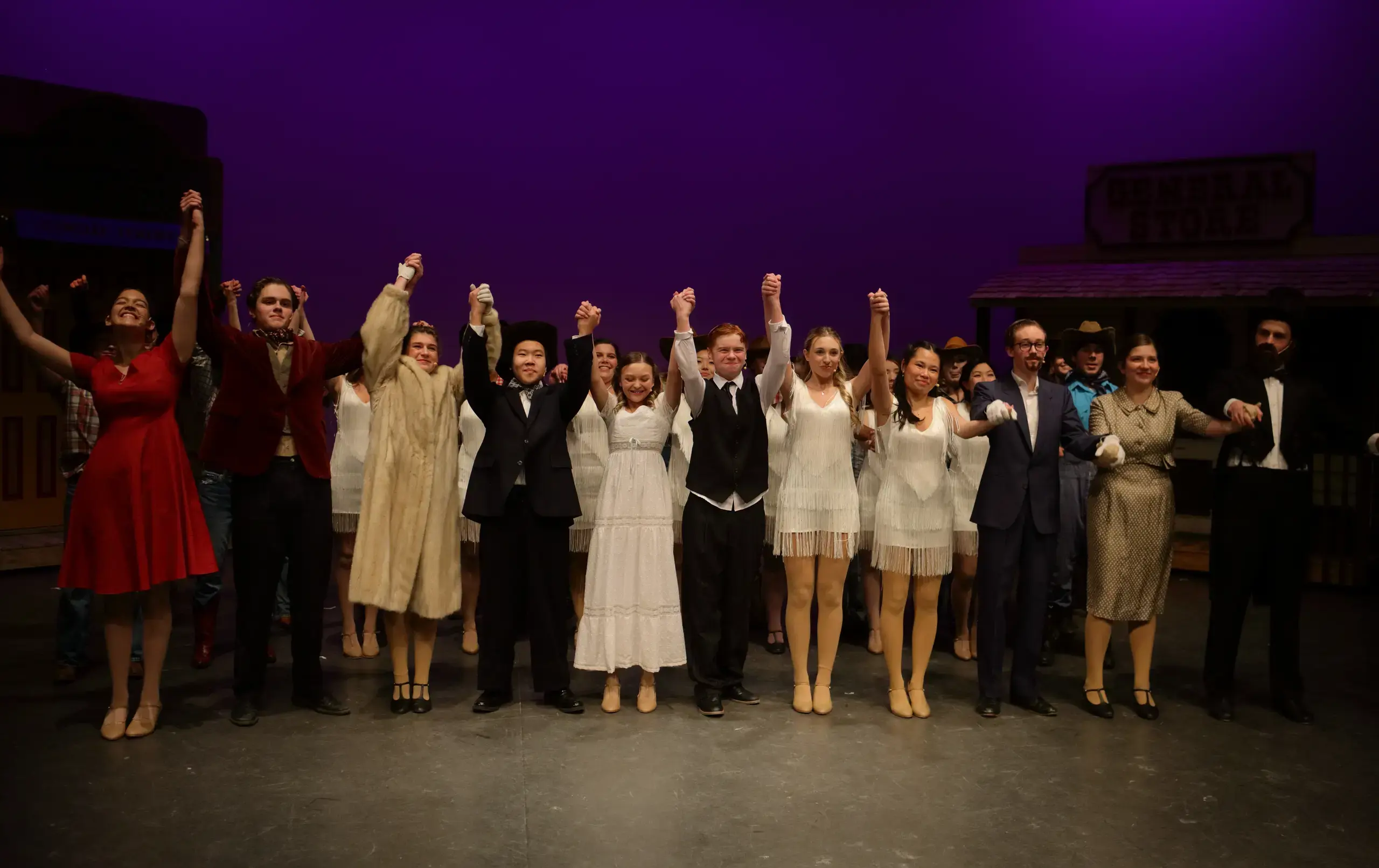 Students raising hands before a bow at one of the many amazing musical performances