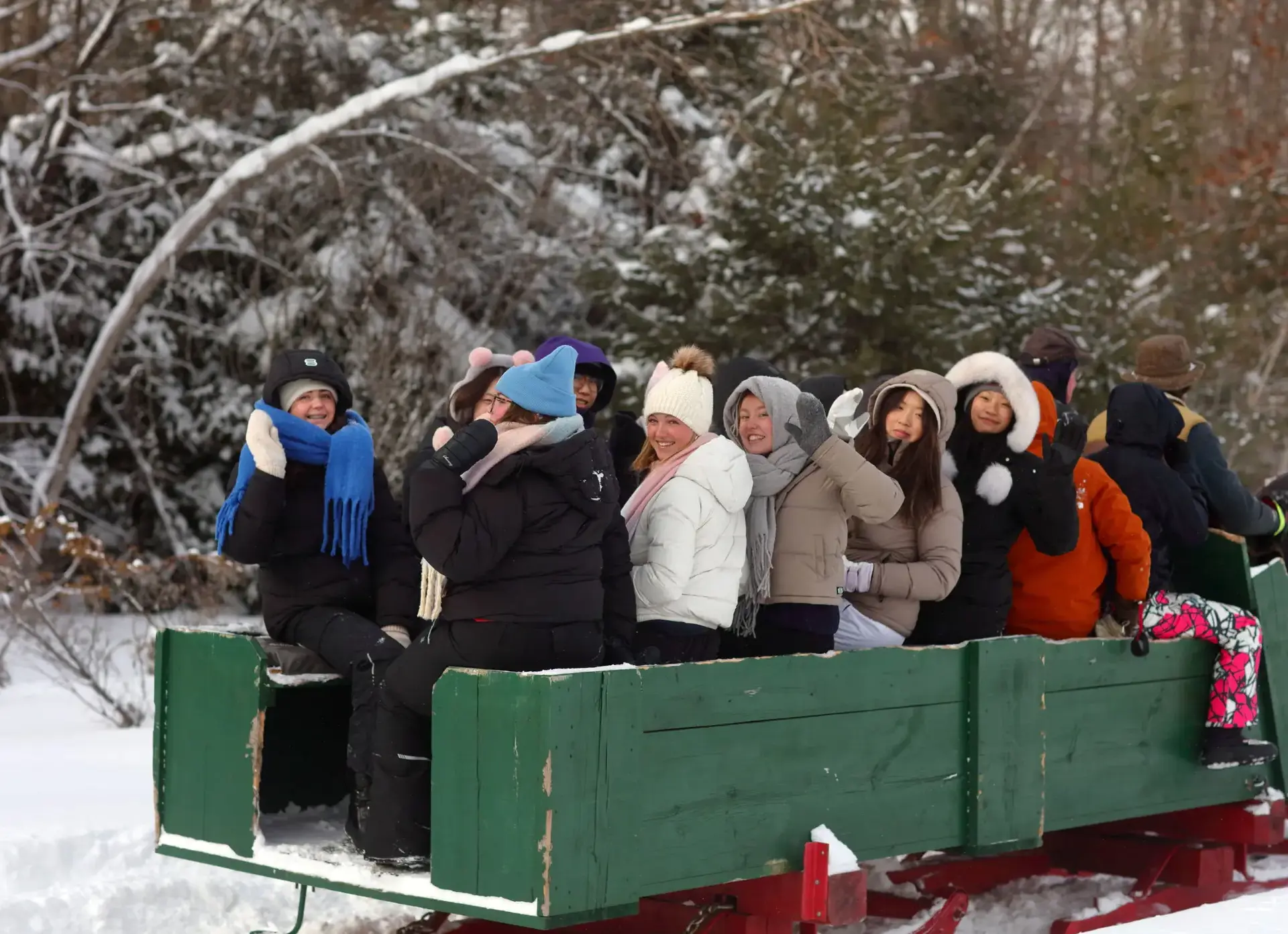 Students waving from sleigh