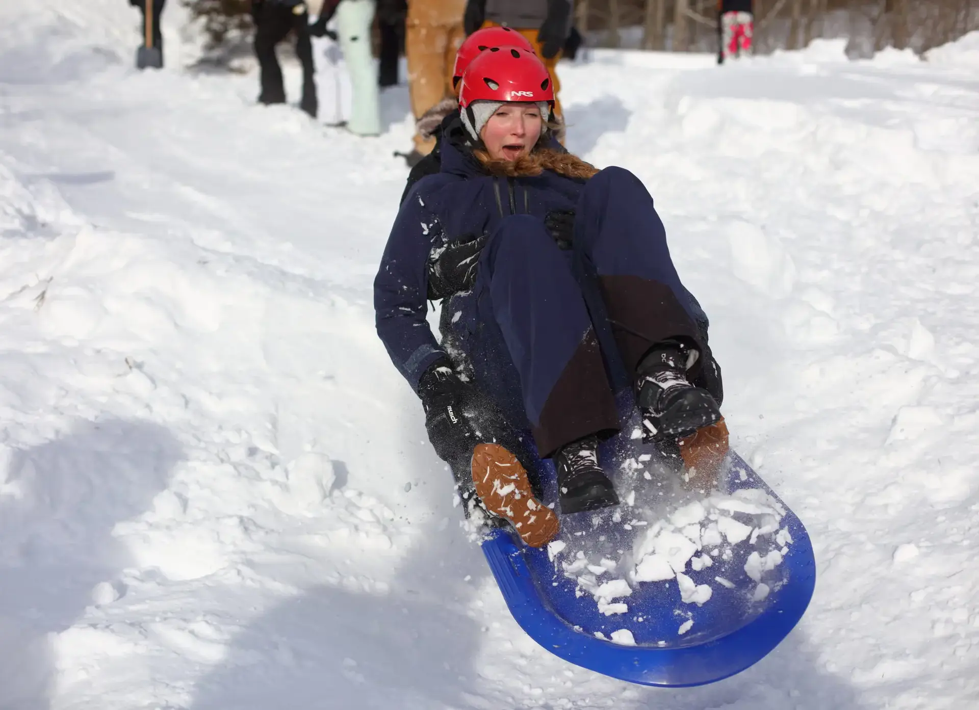 Student sledding, airborne