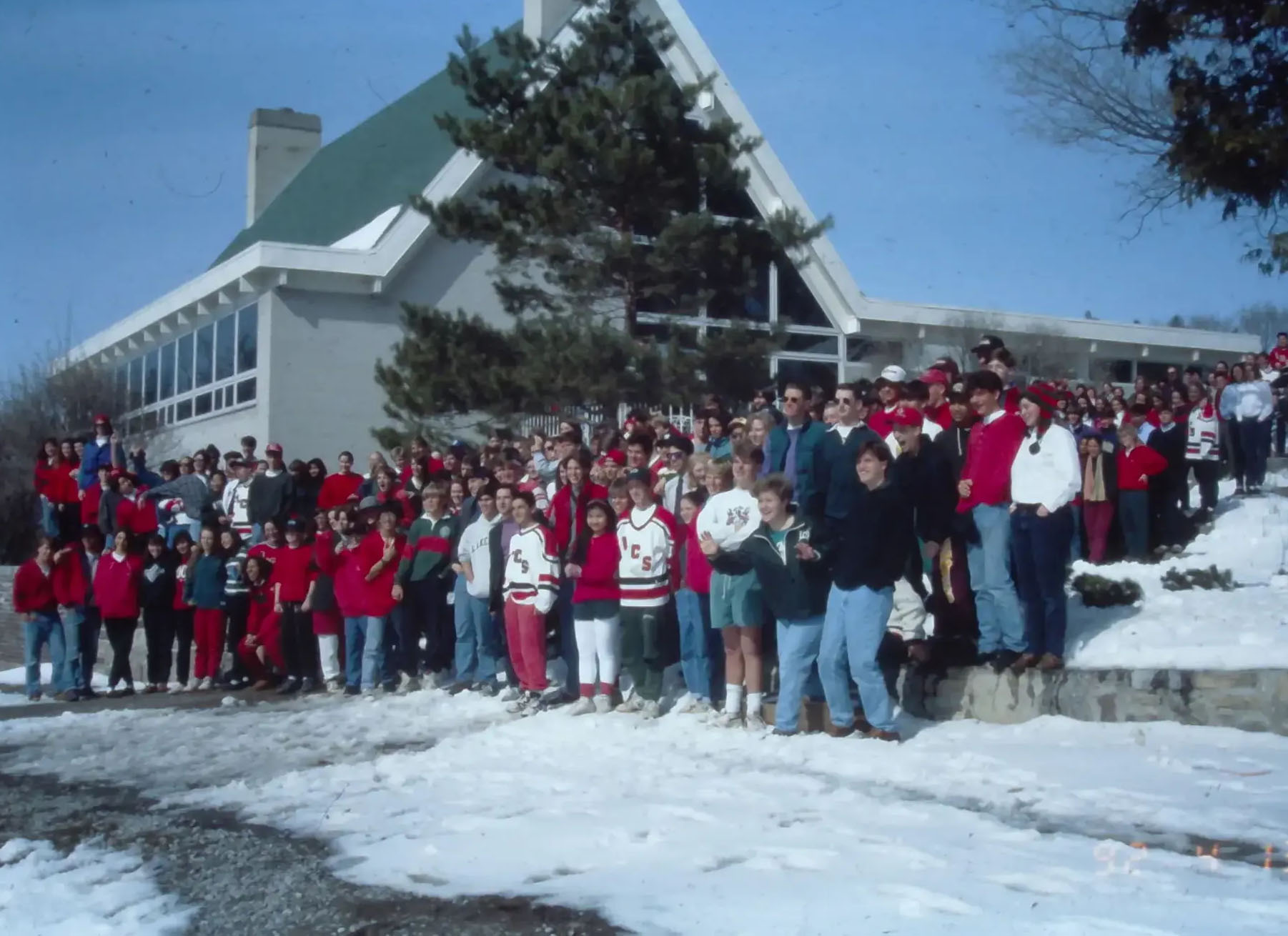 Archival photograph of students in winter gear, standing outside building
