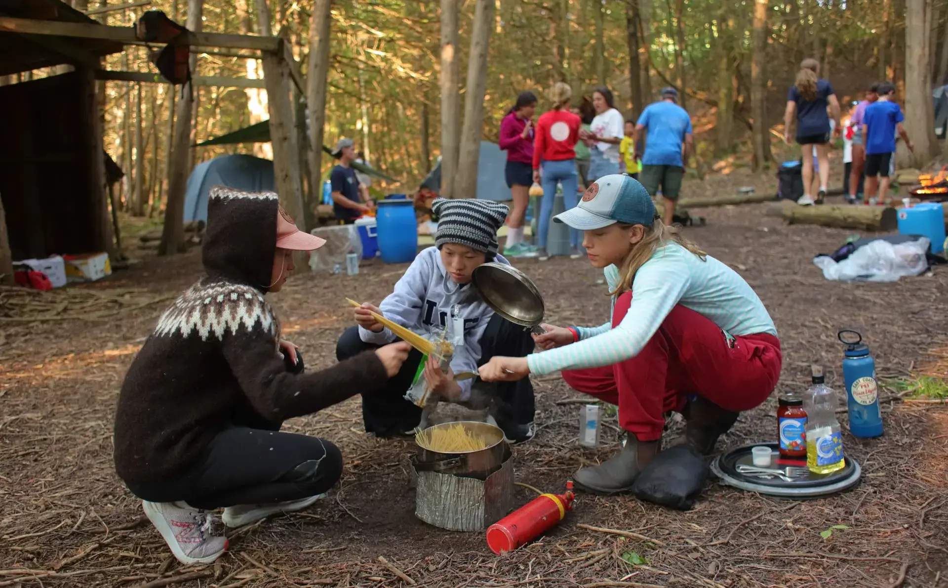 Students cooking over campfire