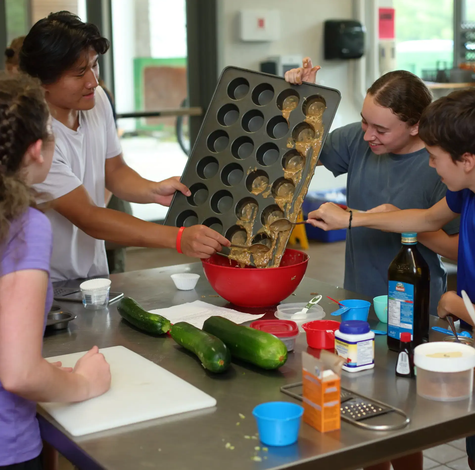 Campers tipping batter from tray