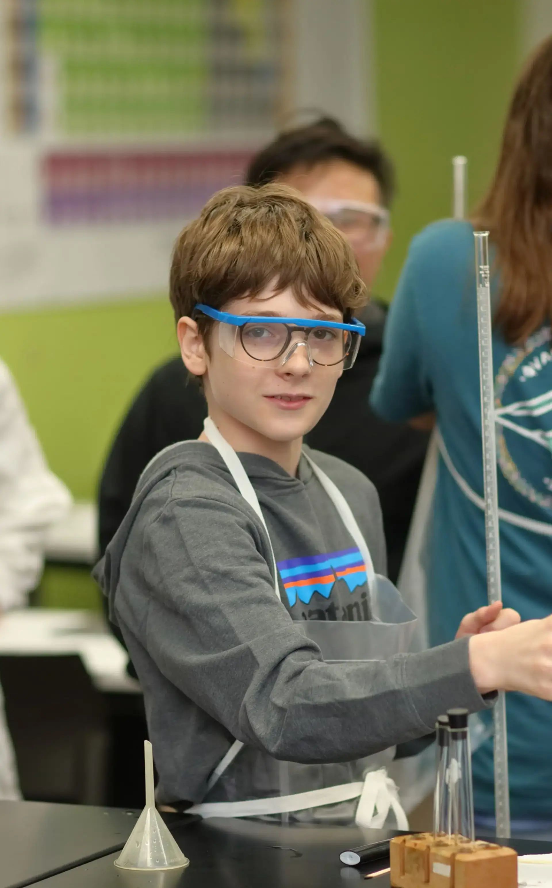 Student wearing protective glasses in chemistry session