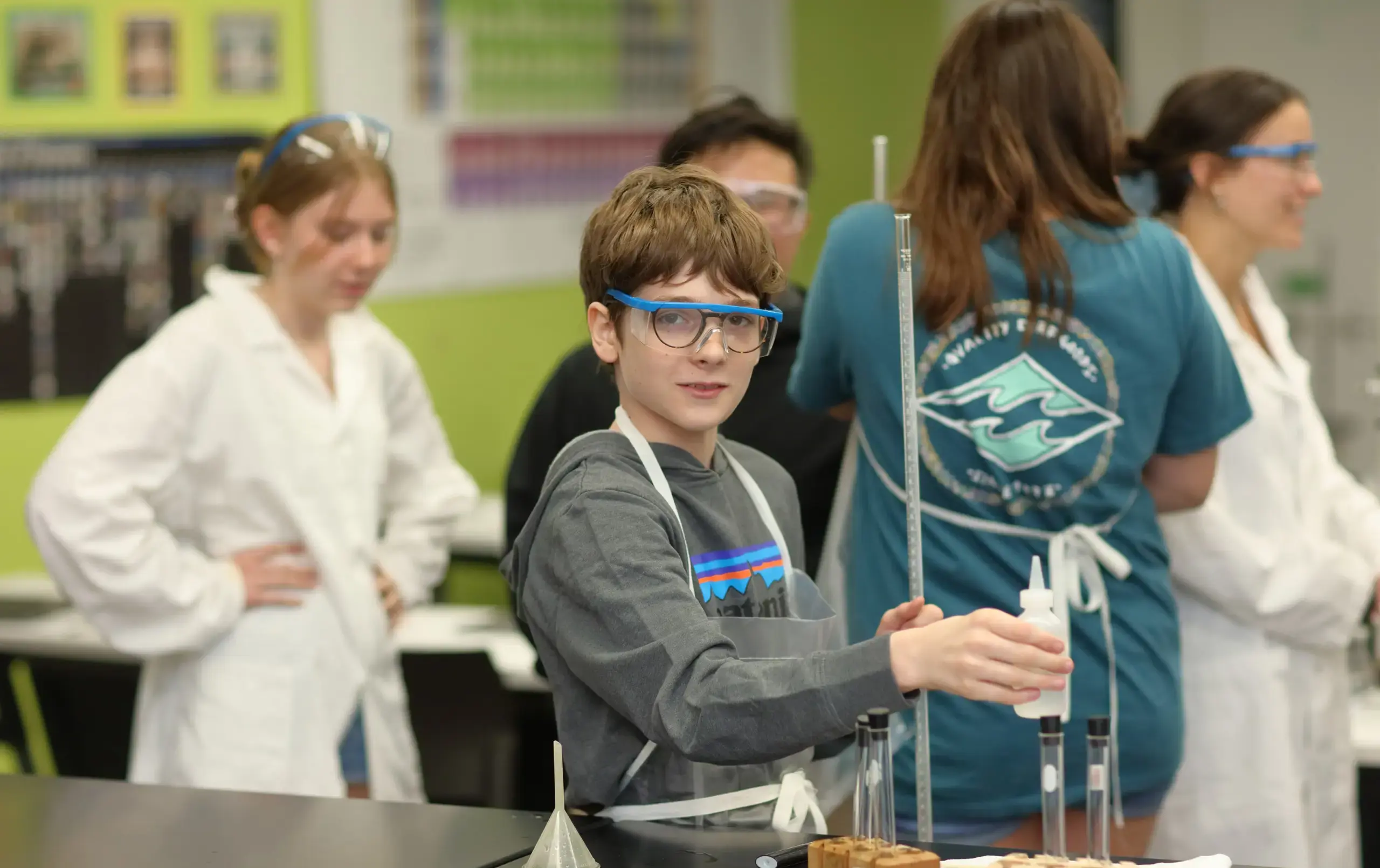 Student wearing protective glasses in chemistry session