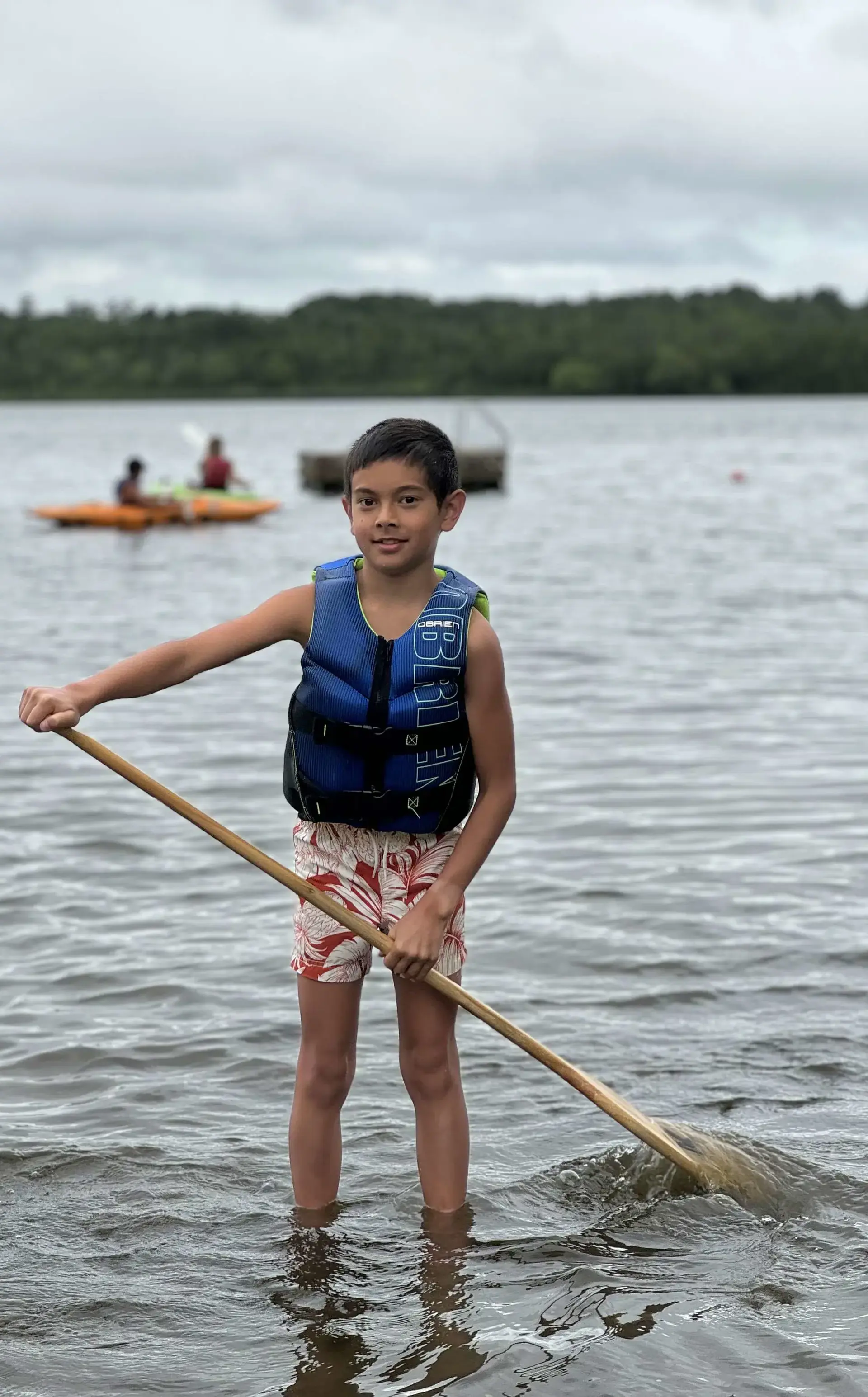 Student standing ankle-deep in lake