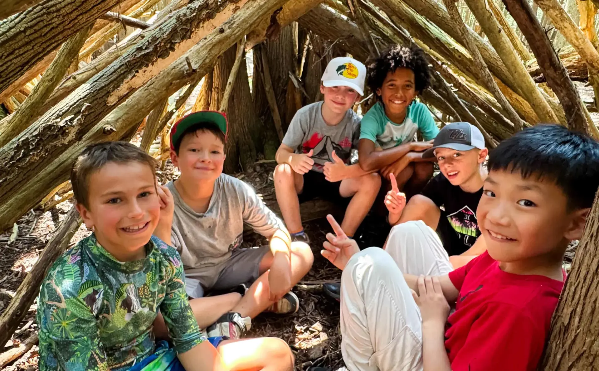 Students in makeshift wood den