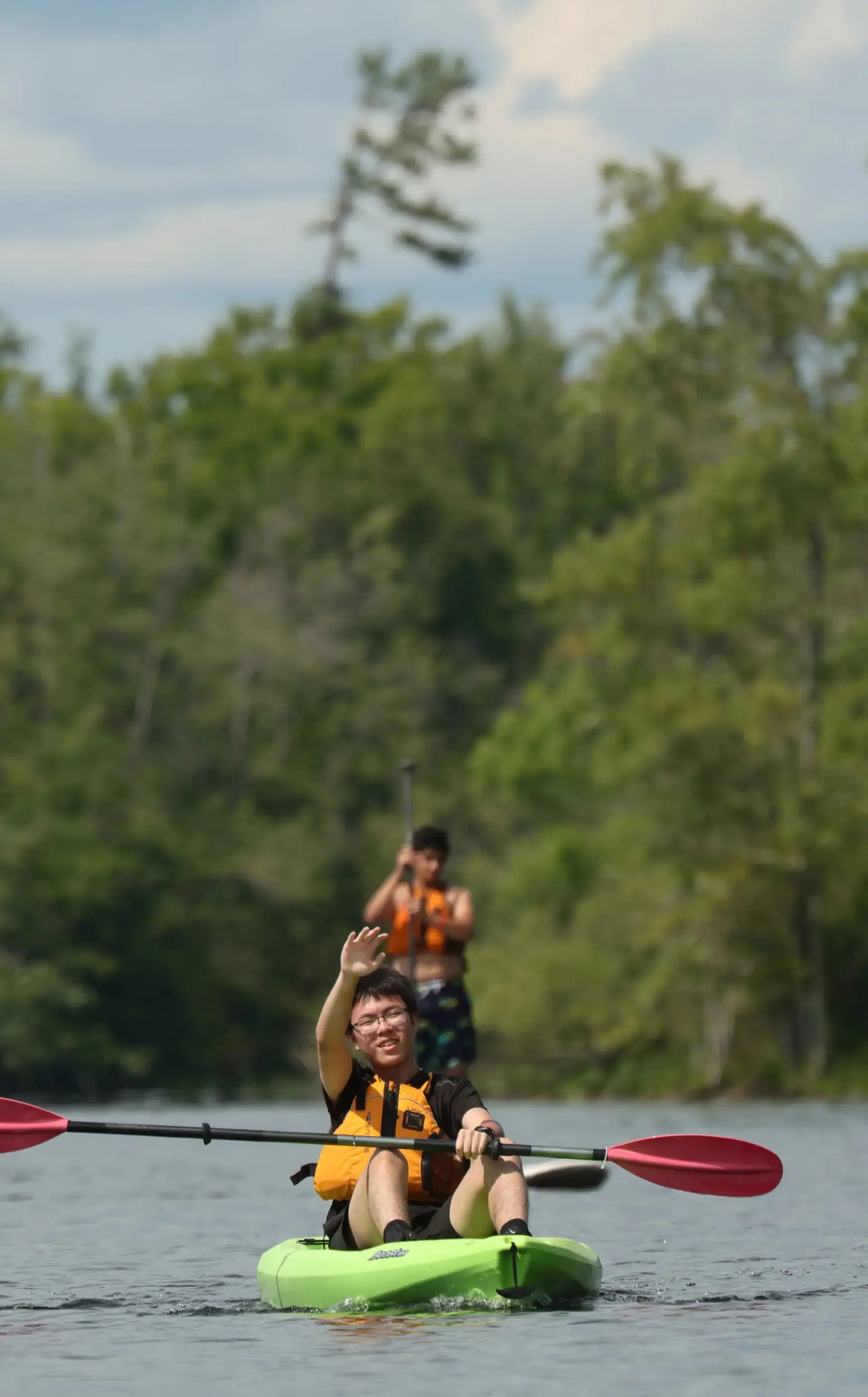 Studing waving from kayak