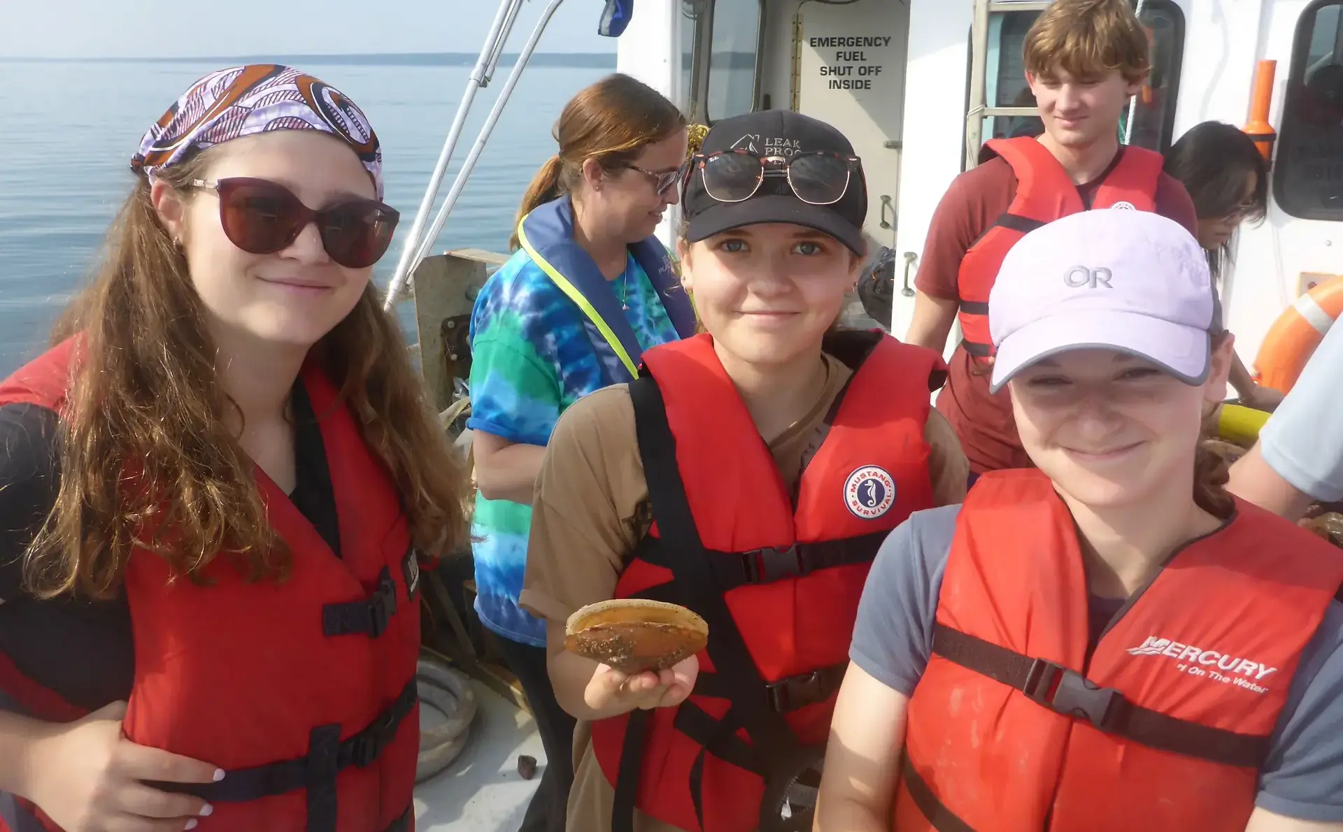 Students wearing life jackets on marine biology trip