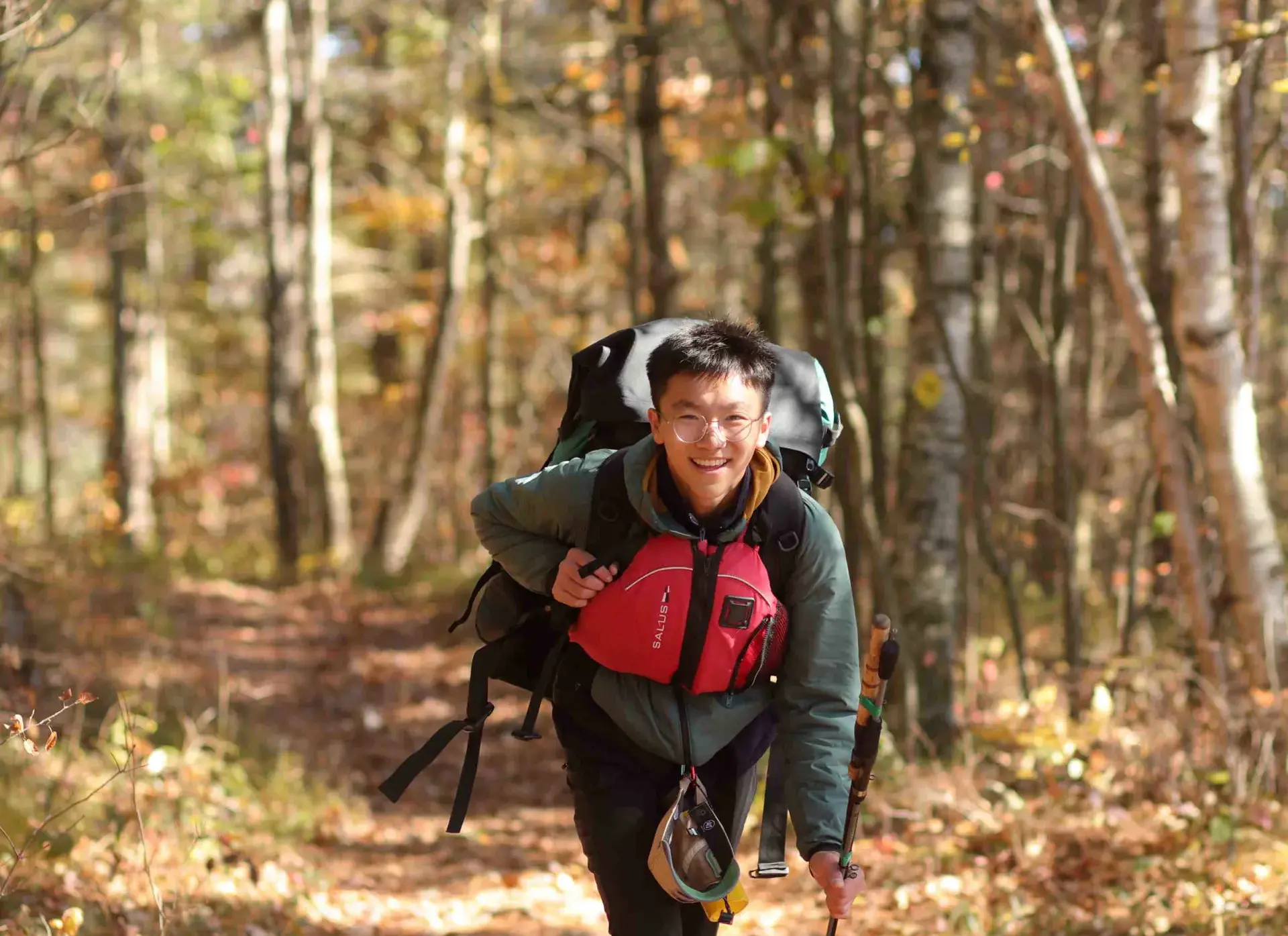 Student hiking through forest