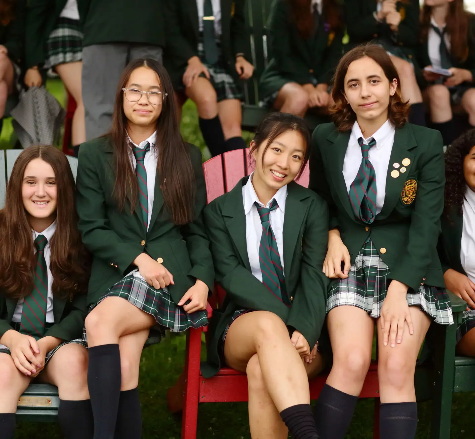 Four smiling students in uniform