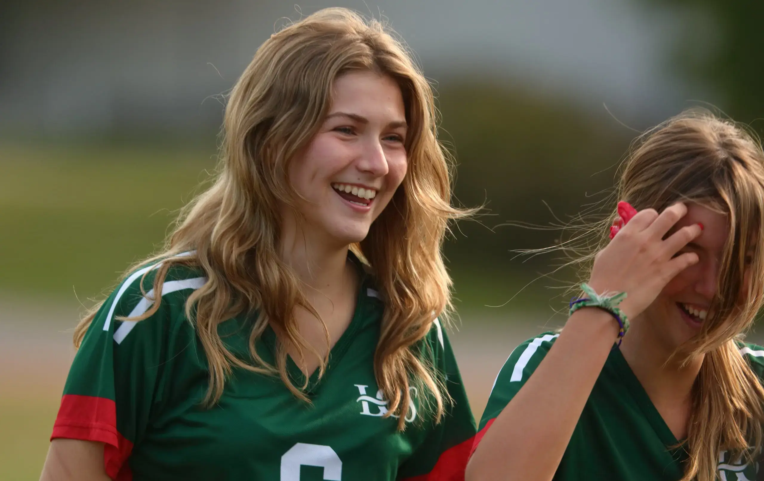 Smiling student in athletics jersey