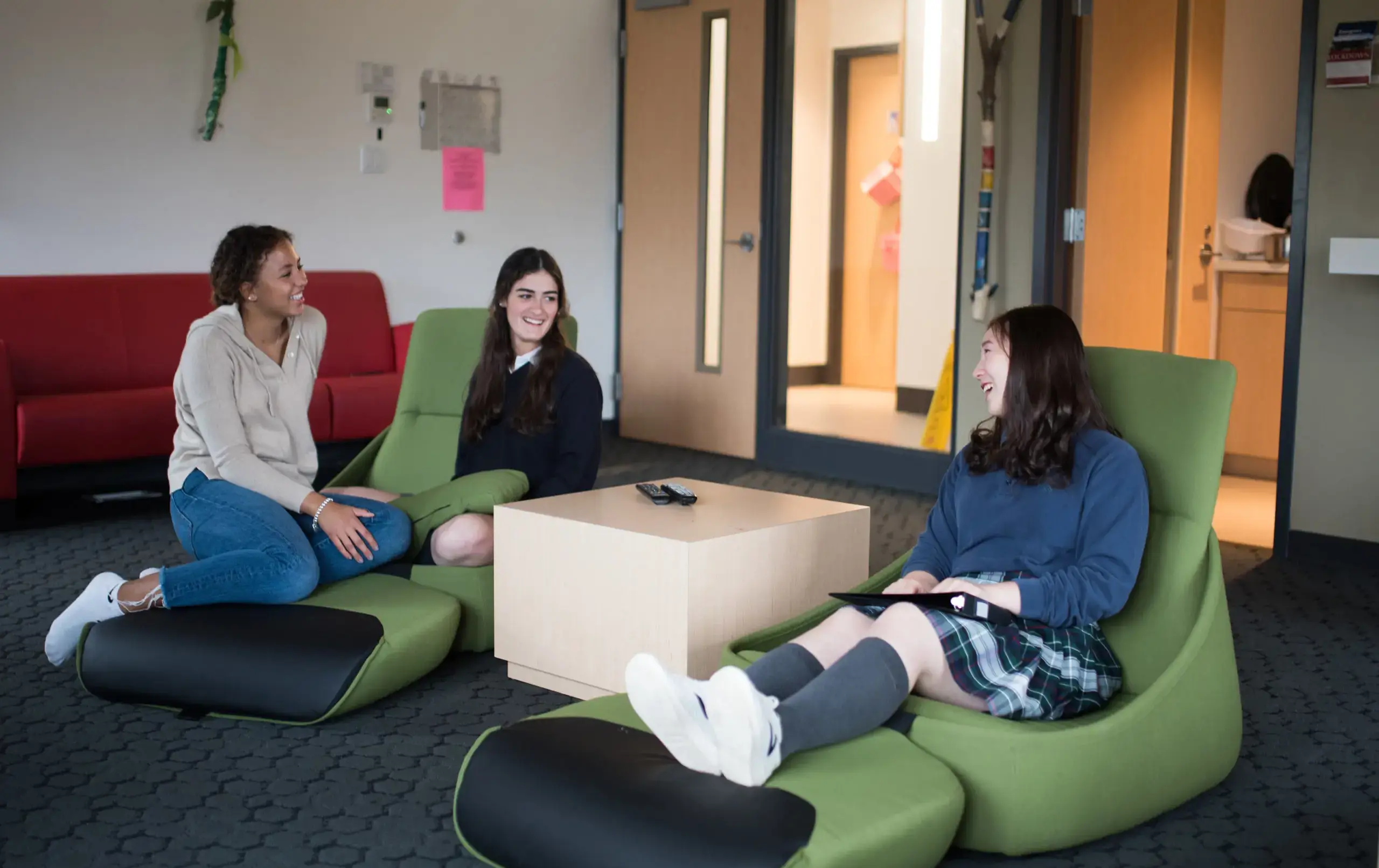Three students relaxing in common area
