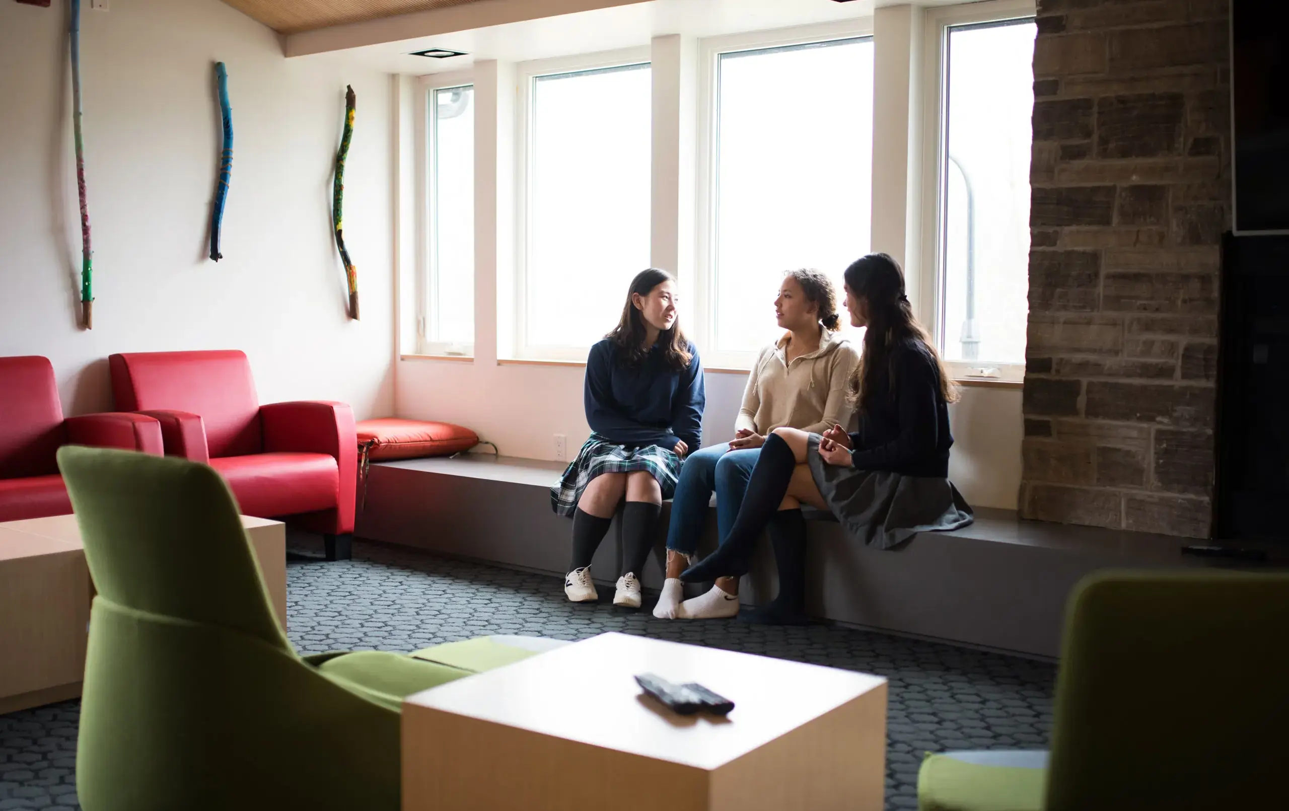 Three students sitting together in common area