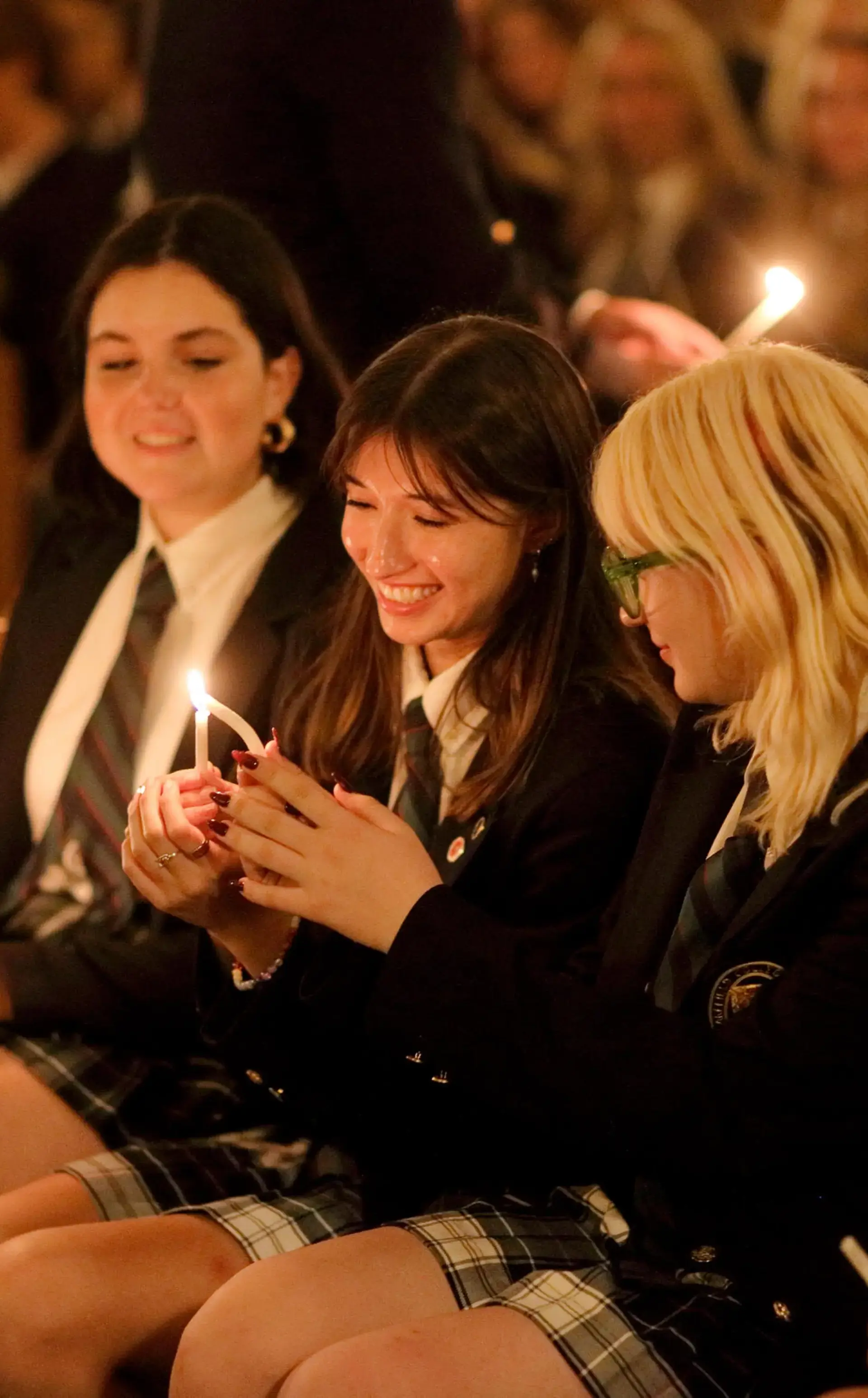 Students lighting candles in chapel