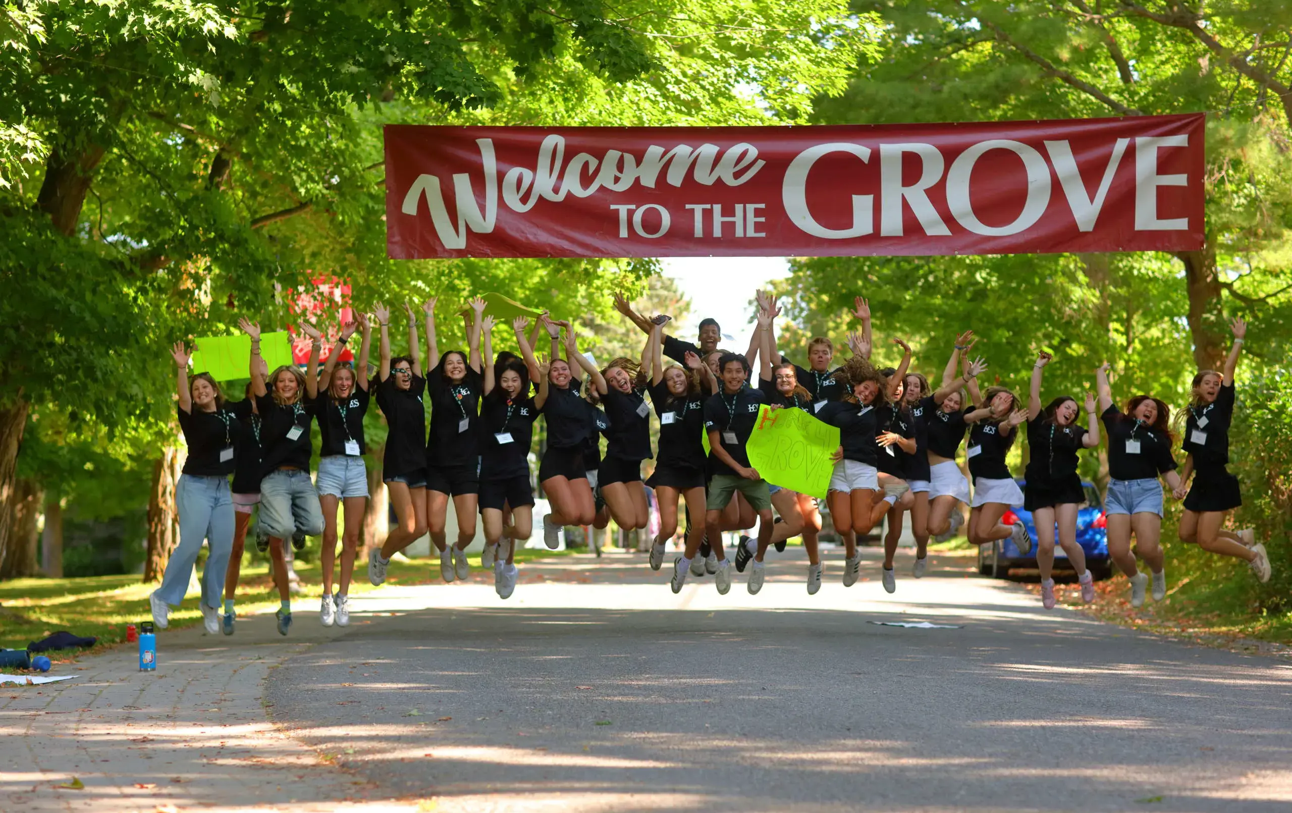 Students holding banner and jumping