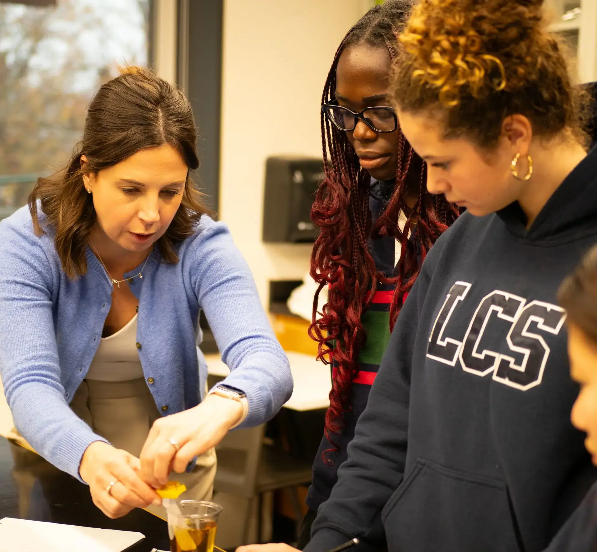 Teacher demonstrating something to students during lesson