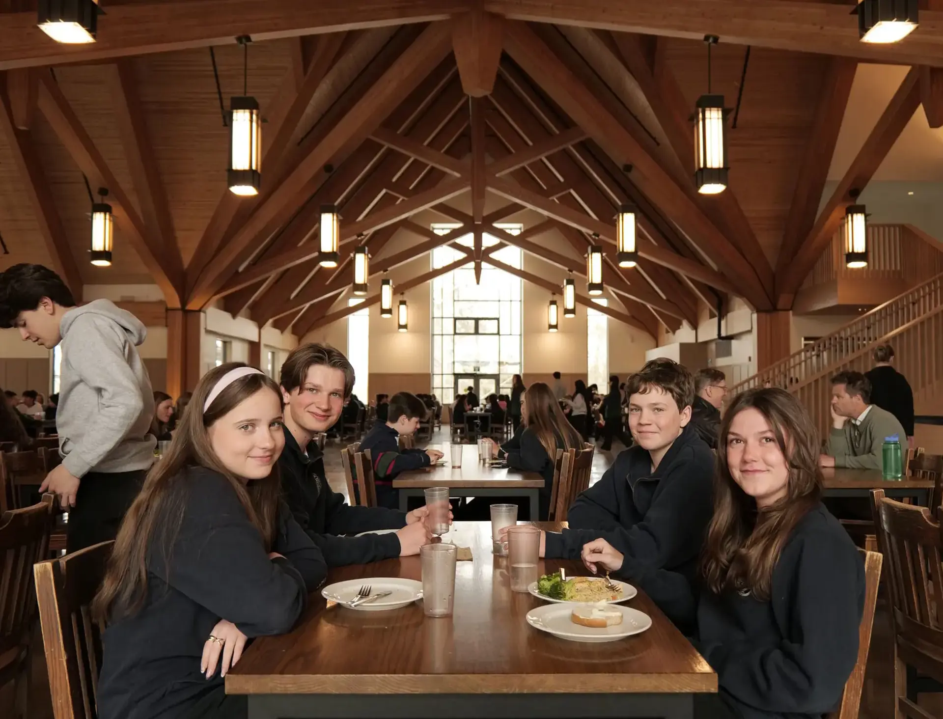 Students sitting at long tables in dining hall