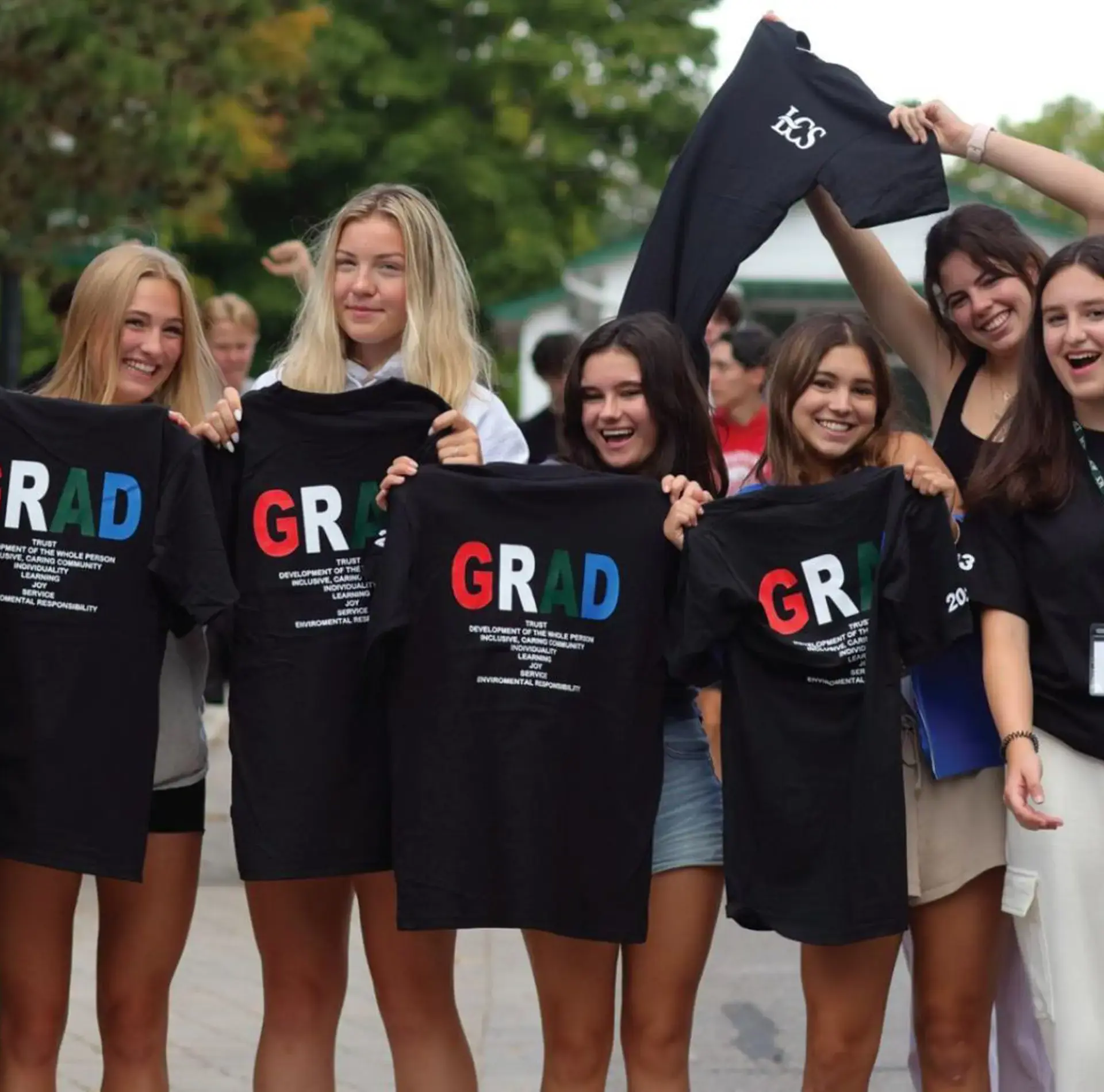 Students wearing graduate t-shirts